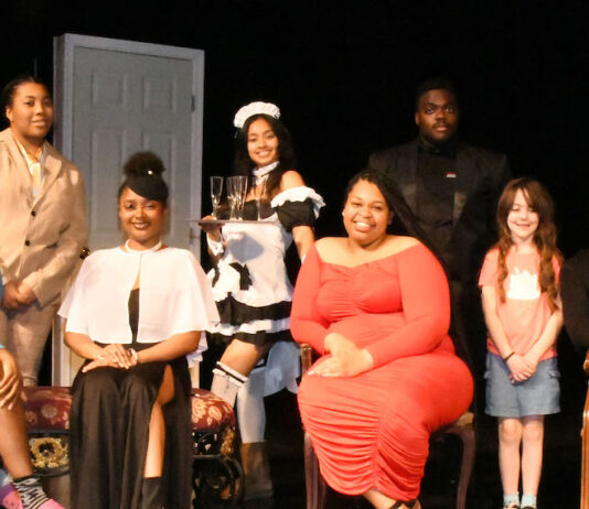 (L-r) Cast members Chaleese Chankins, Ciara Andre, Bria williams Ebube Maduka, Sonia Heredia, Jessica Taylor; and prone on the floor is Maddie Anderson Pomerleau, in a scene for Clue: On Stage