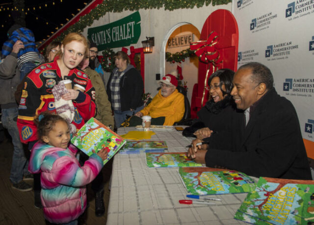 Ben Carson giving Why America Matters´ books to children at Schelville DE