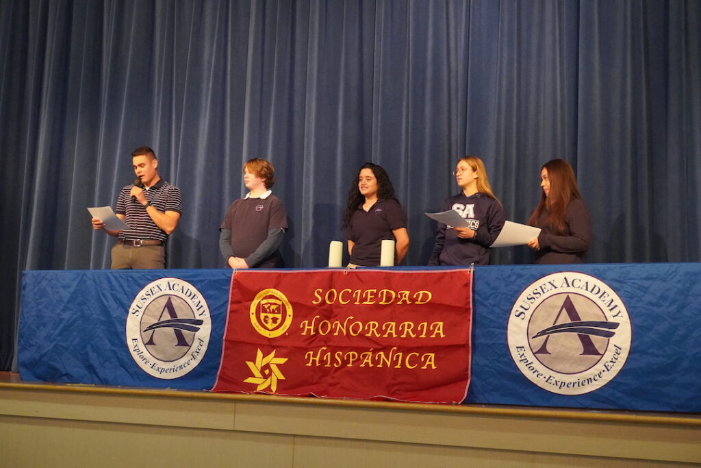 Leading the induction ceremony are (l-r) World Language Honor Society Advisor Nico Caceres, Treasurer Oliver Graves, President Jaziz Carvahal-Pecheco, Vice President Katya Geyer and Secretary Katerine Amador-Ovalle. Not pictured is Historian Karina Lopez. (Photo courtesy Sussex Academy)