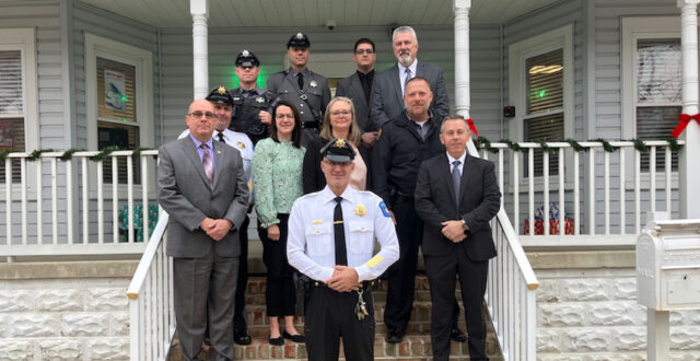 Top row, left to right: Senior Corporal Louis Simms, Corporal Brian O'Hearn, Jesse Reynold, DPAC Administrator John Feehan. Second row, left to right: Lieutenant Keith Darling, Felton Town Manager Amy Thomas, Assessor Amber McKinery, Assessor James Azato. Third row, left to right: Chief Richard McCabe and POST/DPAC Executive Director Sean E. Moriarty with Felton Police Chief Chris Guild (in front).