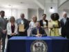 Gov. Meyer announces partnership for $50 million in medical debt elimination Gov. Meyer signing partnership for $50 million in medical debt elimination. (Photo courtesy Gov. Meyer Office).