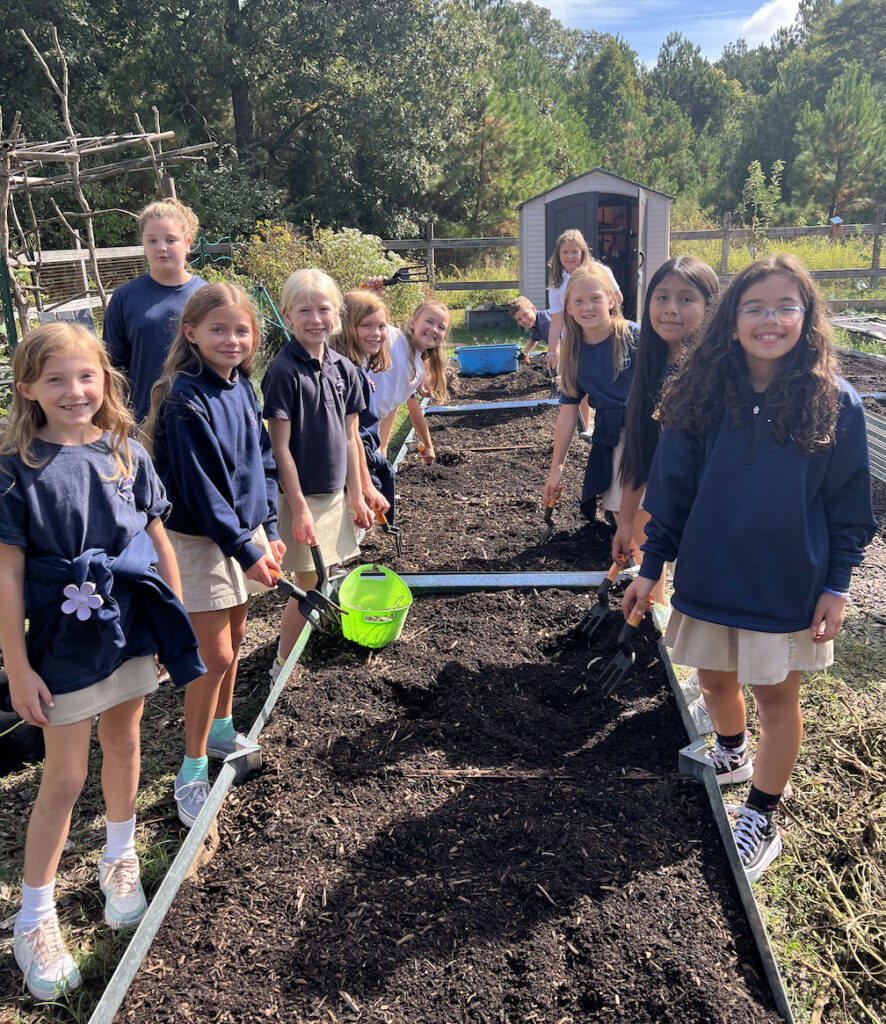 Preparing the soil for planting are (left, front to back) Addy Reed, Kama Forester, Millie Eakins, Nora Furlong, Quinn Albert and Sawyer Humphreys. Right, front to back, are Isabella Tattersall, Sayuri Perez Perez, Aubrey Savage, Lily Hein and Chance Edwards.

