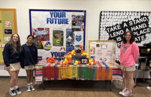 Sussex Academy students observe traditional Mexican holiday Day of the Dead: Sussex Academy World Language Honor Society members (l-r) Leni Kuska, Priya Haldar and Karina Lopez display the ofrenda they created to observe the Day of the Dead (Photo cortesy Sussex Academy)