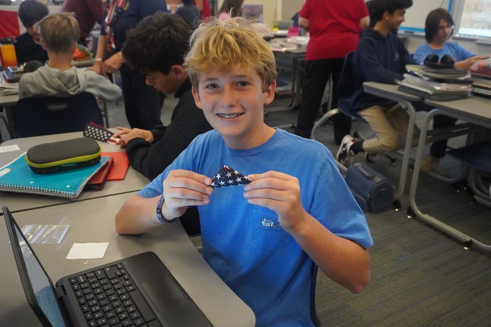 Flag 1: Sussex Academy seventh grader Gavin Robertson displays the pocket flag he created for U.S. troops.