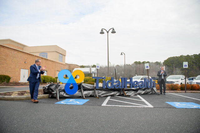 TidalHealth-Atlantic-Unveiling-2026: Don Owrey, MBA, FACHE, president of TidalHealth Atlantic, left, and Steve Leonard, Ph. D., MBA, FACHE, president and CEO of TidalHealth, applaud after unveiling TidalHealth signage that will be added to the TidalHealth Atlantic building.