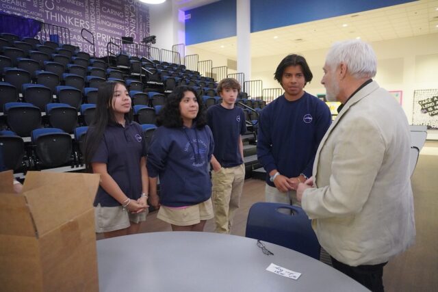 Students (l-r) Zighel Guevara-Yoc, Alison Fragoso-Perez, Joseph Duff and Danny Chavez-Ramirez speak with Holocaust educator Steve Gonzer after his presentation.