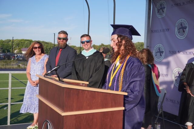 Class President Karina Lopez, right, instructs classmates to turn their tassels with (l-r) Executive Board Vice President Erin Perchiniak, Executive Board President Dr. Ed Hale and Head of School Kyle Bentley.