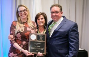 At Annual Gala, atTAcK addiction honors those making a difference in the fight against addiction atTAcK addiction board members Fran Russo-Avena (center) and Karl Fischer present atTAcK addiction's highest honor, the Medal of Honor, to Joanna Champney, director of the Delaware Division of Substance Abuse and Mental Health, the organization's Oct. 22 Be a Hero Gala. (Photo courtesy atTAck addiction)