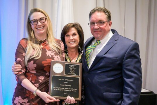 At Annual Gala, atTAcK addiction honors those making a difference in the fight against addiction atTAcK addiction board members Fran Russo-Avena (center) and Karl Fischer present atTAcK addiction's highest honor, the Medal of Honor, to Joanna Champney, director of the Delaware Division of Substance Abuse and Mental Health, the organization's Oct. 22 Be a Hero Gala. (Photo courtesy atTAck addiction)