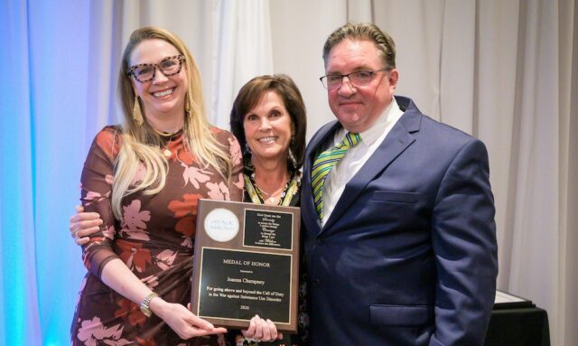 Gala Joanna Champney Medal of Honor 102226 atTAcK addiction board members Fran Russo-Avena (center) and Karl Fischer present atTAcK addiction's highest honor, the Medal of Honor, to Joanna Champney, director of the Delaware Division of Substance Abuse and Mental Health, the organization's Oct. 22 Be a Hero Gala. (Photo courtesy atTAck addiction)